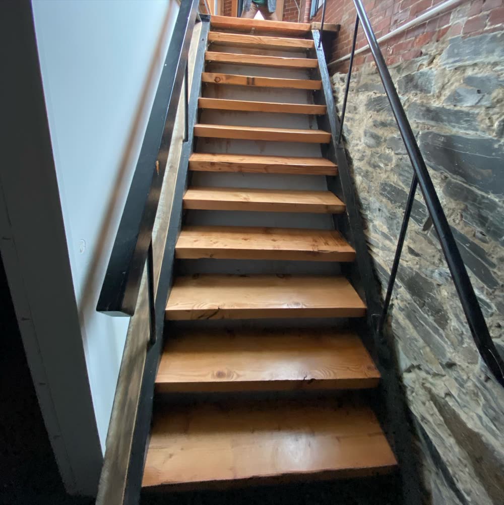 Wood stair treads in a brick stairwell