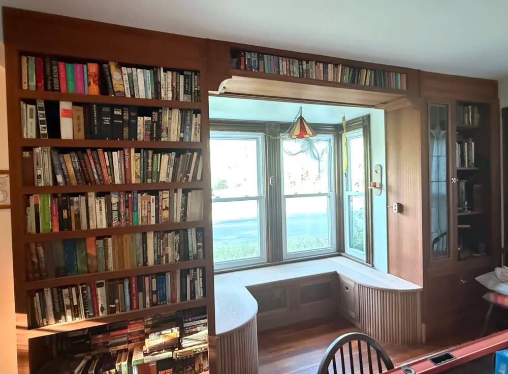 Library bookcases around a bay window