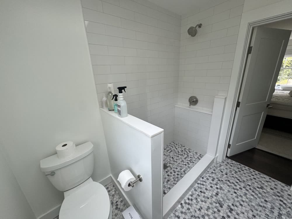 Walk-in shower with pebble floor