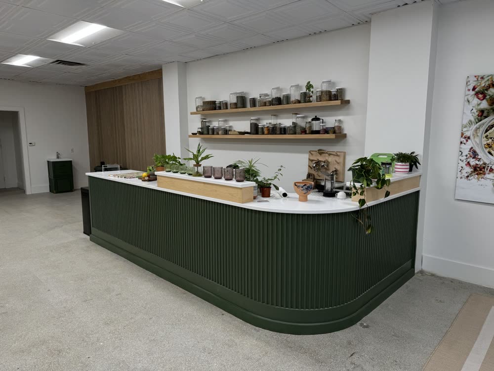 Curved counter with green fluted paneling